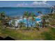 Picturesque community pool surrounded by lush landscaping and swaying palm trees, with bay views at 5277 Isla Key S Blvd # 422, St Petersburg, FL 33715