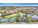An aerial view captures the community's amenities including a pool, pond, and tennis and basketball courts at 6328 Desert Peace Ave, Land O Lakes, FL 34639