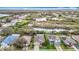 Stunning aerial view of a residential neighborhood showcasing homes with lush landscaping, ponds, and natural surroundings at 6328 Desert Peace Ave, Land O Lakes, FL 34639