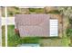 Aerial view of the home featuring a large roof and screened in porch at 6328 Desert Peace Ave, Land O Lakes, FL 34639