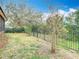 Backyard with a wrought iron fence line and lush landscaping at 6328 Desert Peace Ave, Land O Lakes, FL 34639