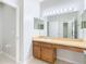 Bathroom vanity area with a large mirror, vanity lights, and sink at 6328 Desert Peace Ave, Land O Lakes, FL 34639
