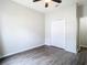 Bright bedroom with wood-look floors, a ceiling fan, and closet access at 6328 Desert Peace Ave, Land O Lakes, FL 34639