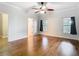 Primary bedroom featuring hardwood floors, crown moulding, ceiling fan and ample natural light at 6328 Desert Peace Ave, Land O Lakes, FL 34639