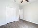 Bright bedroom with wood-look floors, a ceiling fan, closet, and ensuite bathroom access at 6328 Desert Peace Ave, Land O Lakes, FL 34639