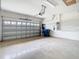 Spacious garage with an automatic door, epoxy floors and wall paneling at 6328 Desert Peace Ave, Land O Lakes, FL 34639