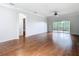 Spacious living room with hardwood floors, ceiling fan, crown moulding, and glass sliding doors at 6328 Desert Peace Ave, Land O Lakes, FL 34639