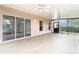 Spacious screened porch with ceiling fans and sliding glass doors to the backyard at 6328 Desert Peace Ave, Land O Lakes, FL 34639