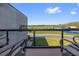 Modern balcony with metal railings overlooking a lush green field with clear blue skies at 6500 Motor Enclave Way # 513, Tampa, FL 33610