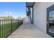 Building's exterior showcasing a modern design with a sleek fence, green grass, and an open concrete porch at 6500 Motor Enclave Way # 513, Tampa, FL 33610