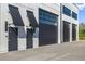 Modern building exterior featuring black doors and large windowed garage entrances with awnings and sleek design at 6500 Motor Enclave Way # 513, Tampa, FL 33610