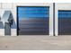 Modern building exterior featuring a large black garage door with upper windows and gray concrete facade at 6500 Motor Enclave Way # 513, Tampa, FL 33610