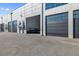 Exterior of unit with large garage doors and modern design, showcasing the building's architecture at 6500 Motor Enclave Way # 513, Tampa, FL 33610