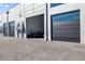Exterior of unit with large garage doors and modern design, showcasing the building's architecture at 6500 Motor Enclave Way # 513, Tampa, FL 33610