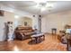 Cozy living room features wood-look flooring, fan, and comfortable seating at 713 Bel Air Ave, Sun City Center, FL 33573