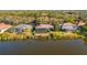 Aerial view of waterfront homes featuring screened patios and backyard pools at 7226 Bryce N Pt, Pinellas Park, FL 33782