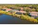 Aerial shot showcasing a home with a screened-in pool and private dock on the water at 7226 Bryce N Pt, Pinellas Park, FL 33782
