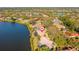 Aerial view of a beautiful lakeside home with a screened-in pool and private dock at 7226 Bryce N Pt, Pinellas Park, FL 33782