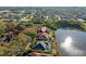 Stunning waterfront home with lush landscaping and mature trees overlooking the serene lake at 7226 Bryce N Pt, Pinellas Park, FL 33782