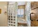 Bathroom featuring a glass block shower, white shutters, and modern fixtures at 7226 Bryce N Pt, Pinellas Park, FL 33782
