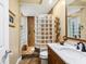 Bathroom featuring a glass block shower, neutral tiling, and a marble countertop vanity at 7226 Bryce N Pt, Pinellas Park, FL 33782