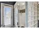 Close-up of a modern glass block shower with white tile and decorative mosaic tile accents at 7226 Bryce N Pt, Pinellas Park, FL 33782