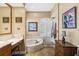 Spacious bathroom with tub, vanity, shutters and decorative artwork at 7226 Bryce N Pt, Pinellas Park, FL 33782