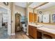 Classic-style bathroom with wood vanity and large mirror, with a toilet and decorative cabinet at 7226 Bryce N Pt, Pinellas Park, FL 33782
