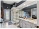 Modern bathroom featuring a granite-topped vanity, glass block shower, and convenient access to an outdoor area at 7226 Bryce N Pt, Pinellas Park, FL 33782
