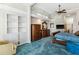 This primary bedroom is complete with a tray ceiling, fan, and large windows at 7226 Bryce N Pt, Pinellas Park, FL 33782