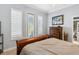 Bedroom with shuttered windows, hardwood furniture and light blue walls at 7226 Bryce N Pt, Pinellas Park, FL 33782