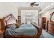 Spacious bedroom featuring a decorative tray ceiling, fan, and large windows with shutters at 7226 Bryce N Pt, Pinellas Park, FL 33782