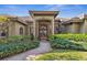 Covered entryway showcasing a beautiful double door entry, lush landscaping, and mature trees at 7226 Bryce N Pt, Pinellas Park, FL 33782