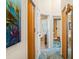 Hallway view leading to the bathroom and tub with an ocean themed art decor at 7226 Bryce N Pt, Pinellas Park, FL 33782