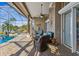 Covered patio with wicker furniture, ceiling fan, and lake view at 7226 Bryce N Pt, Pinellas Park, FL 33782