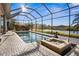 Screened pool with hot tub overlooking the lake at 7226 Bryce N Pt, Pinellas Park, FL 33782