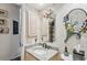 Charming powder room featuring unique wallpaper, decorative mirrors, and a granite-topped vanity at 7226 Bryce N Pt, Pinellas Park, FL 33782