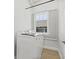 Well-lit laundry room with a modern, white washing machine and window at 734 Newton S Ave, St Petersburg, FL 33701