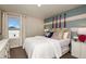 Inviting bedroom featuring a white quilt, colorful accent pillows, and striped wall art at 7647 Peace Lily Ave, Wesley Chapel, FL 33545