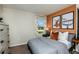 Stylish bedroom with drum-themed art, gray bedding, and natural light from the window at 7647 Peace Lily Ave, Wesley Chapel, FL 33545