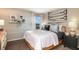Comfortable bedroom with a bed, a bedside table, and unique wall decorations, offering a cozy retreat at 7647 Peace Lily Ave, Wesley Chapel, FL 33545