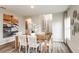 Dining area featuring a wood table, woven chairs, and contemporary decor at 7647 Peace Lily Ave, Wesley Chapel, FL 33545