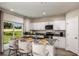 Bright eat-in kitchen features white cabinets, stainless appliances, and a backyard view at 7647 Peace Lily Ave, Wesley Chapel, FL 33545