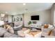 Cozy living room with a large TV, plush seating, and stylish decor at 7647 Peace Lily Ave, Wesley Chapel, FL 33545