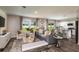 Bright living room with contemporary decor, hardwood floors, and ample seating at 7647 Peace Lily Ave, Wesley Chapel, FL 33545