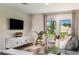 Bright living room with contemporary decor, hardwood floors, and natural light at 7647 Peace Lily Ave, Wesley Chapel, FL 33545