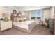 Serene main bedroom with a well-made bed, decorative wall art, and plenty of natural light at 7647 Peace Lily Ave, Wesley Chapel, FL 33545