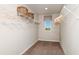 Functional walk-in closet with ample shelving and hanging space, complemented by natural light at 7647 Peace Lily Ave, Wesley Chapel, FL 33545