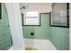 Bathroom featuring original green tile, a bathtub with shower, and natural light at 841 4Th N Ave # 57, St Petersburg, FL 33701