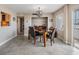 Comfortable dining room with neutral walls, tile flooring, and modern lighting fixture at 841 4Th N Ave # 57, St Petersburg, FL 33701